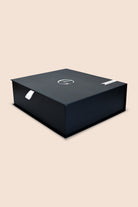 Black box with a logo on a beige background