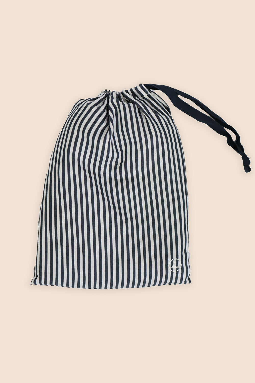 Striped drawstring bag on a beige background