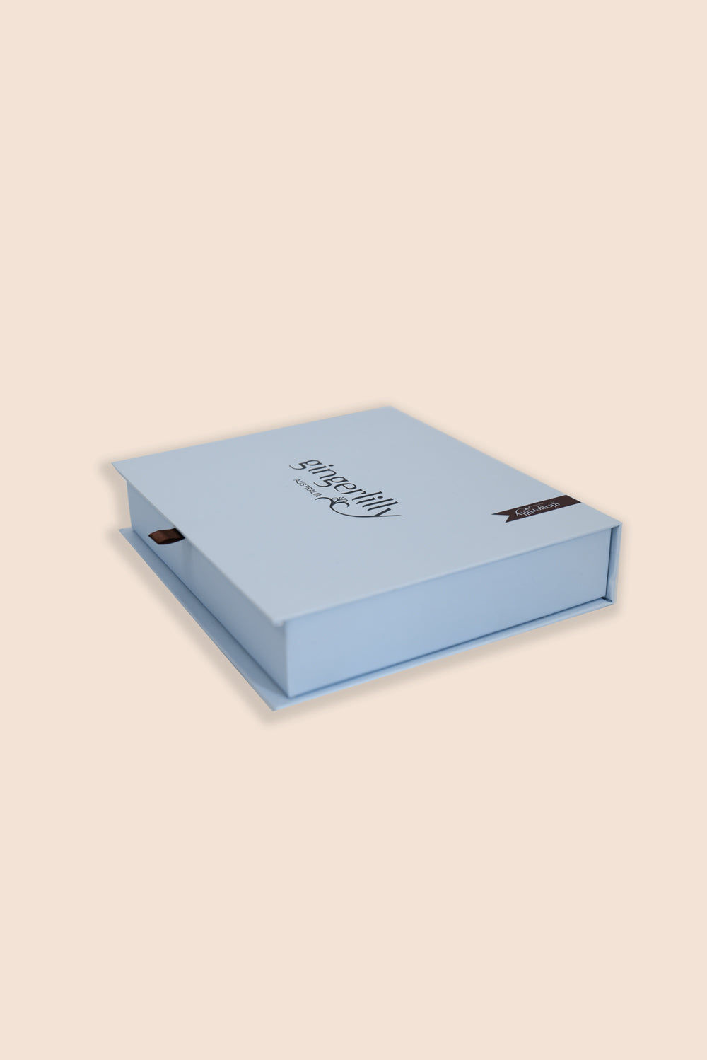 Blue gift box with a brand name on a beige background