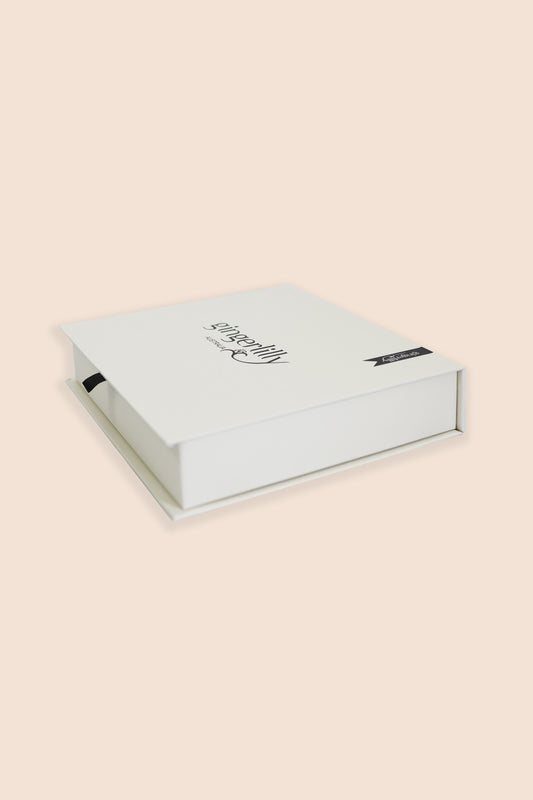 White jewelry box with a brand logo on a beige background