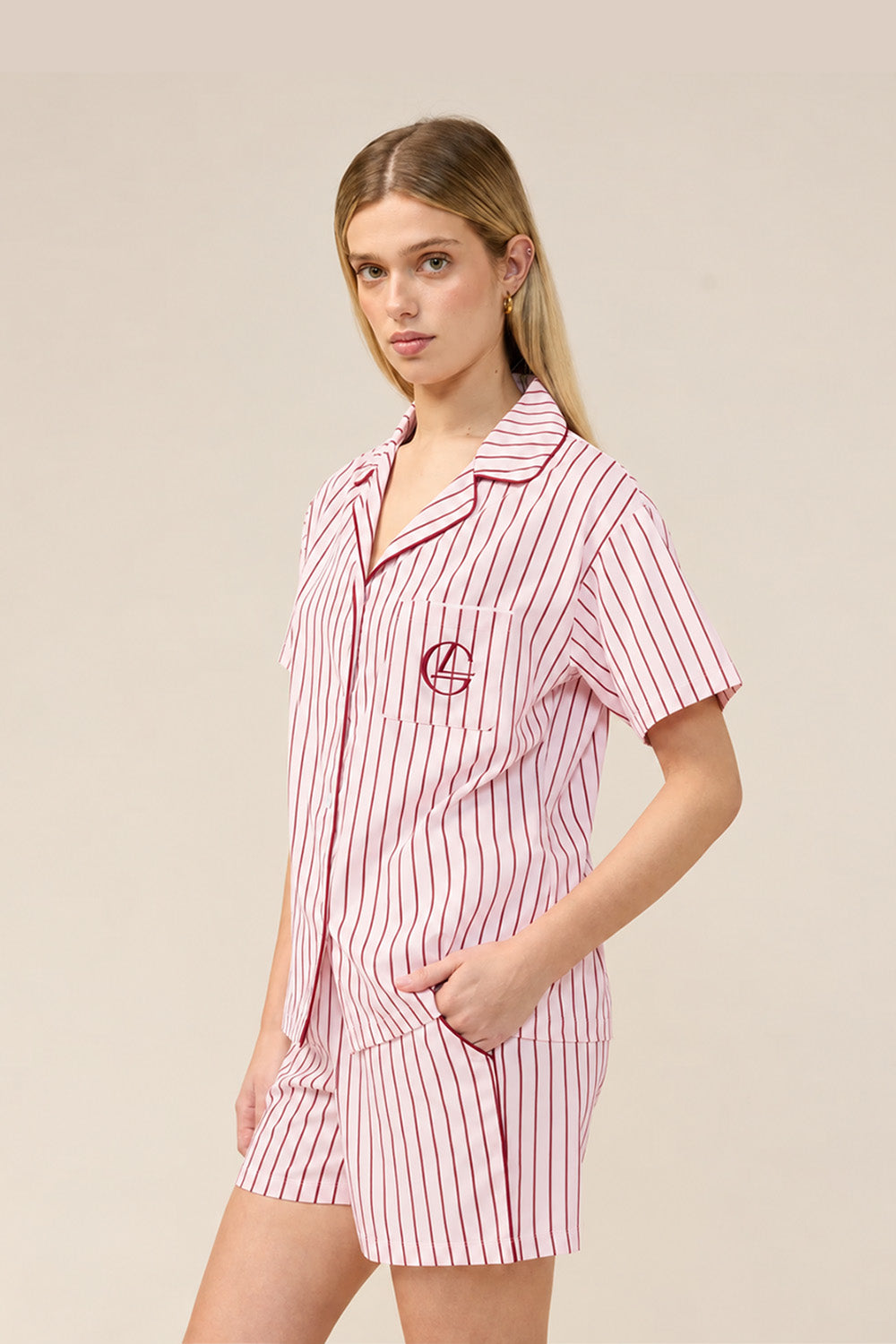 Woman wearing the Poppy Stripe Short PJ Set in Pink, angled front view