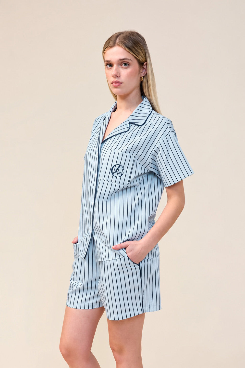 Woman wearing the Poppy Stripe Short PJ Set in Blue, angled front view