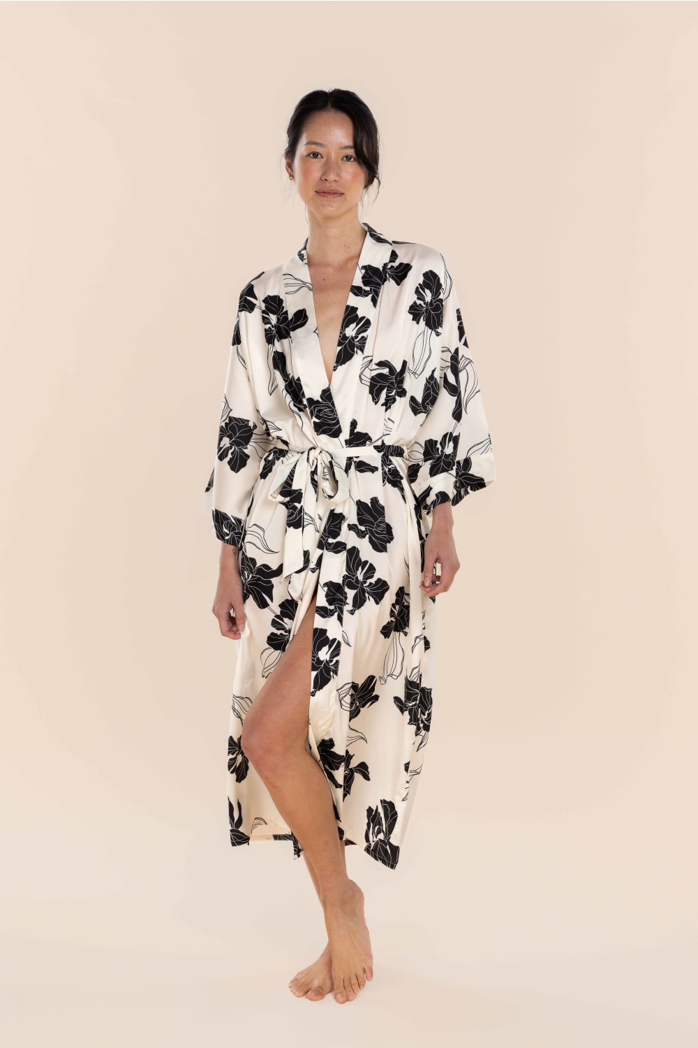 Woman wearing a floral robe on a beige background