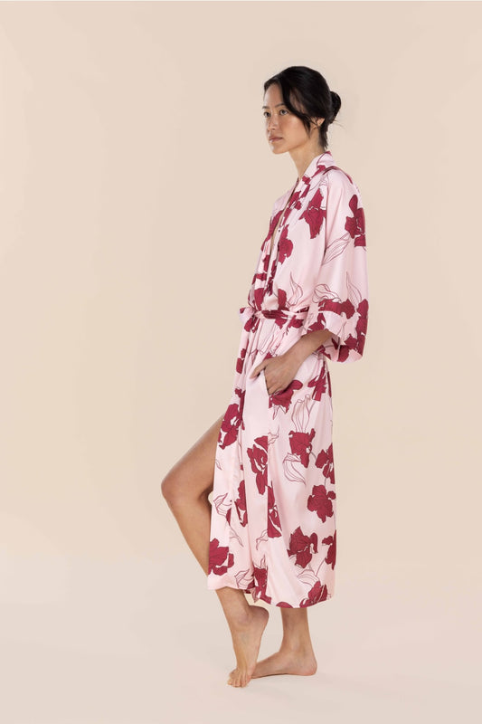 Woman wearing a pink floral robe on a beige background