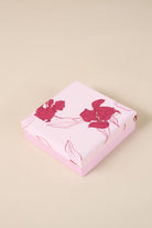 Pink floral gift box from Gingerlilly Sleepwear with red flower designs on lid