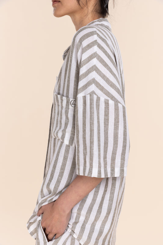 Person wearing a striped shirt with a neutral background