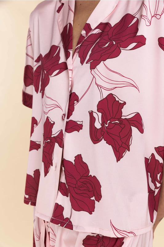 Floral patterned garment with red flowers on a light background