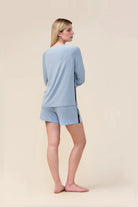 Woman wearing the Solene Long Sleeve Top with Stripe in Blue, back view