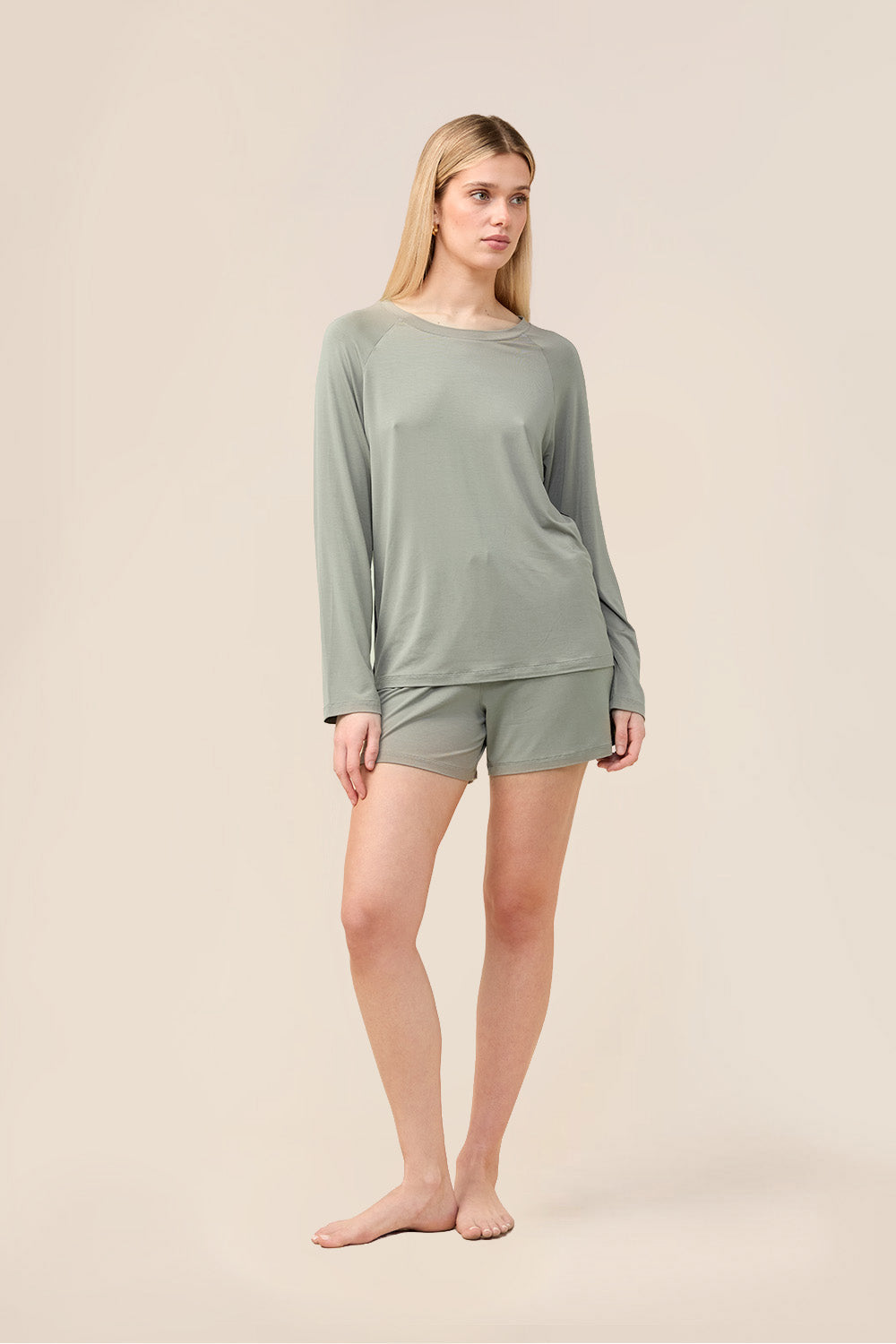 Woman wearing the Solene Long Sleeve Top with Stripe in Olive, front view