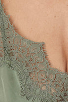 Close-up of a olive green heather silky satin cami and short set lace garment