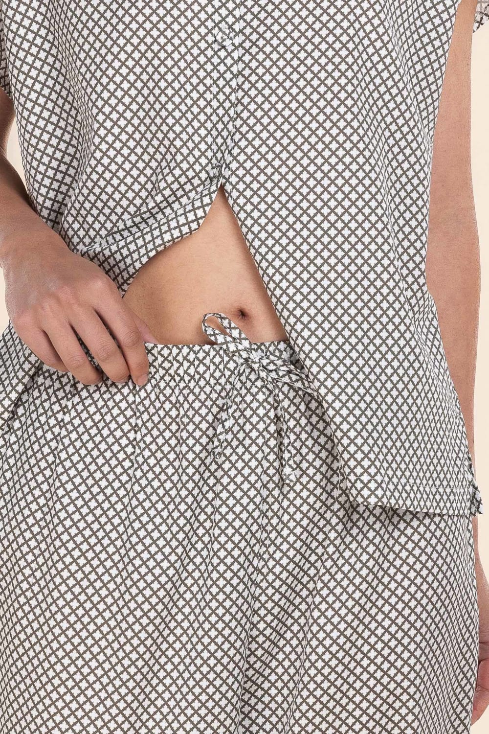 Person wearing a black and white patterned outfit with a focus on the waist area.