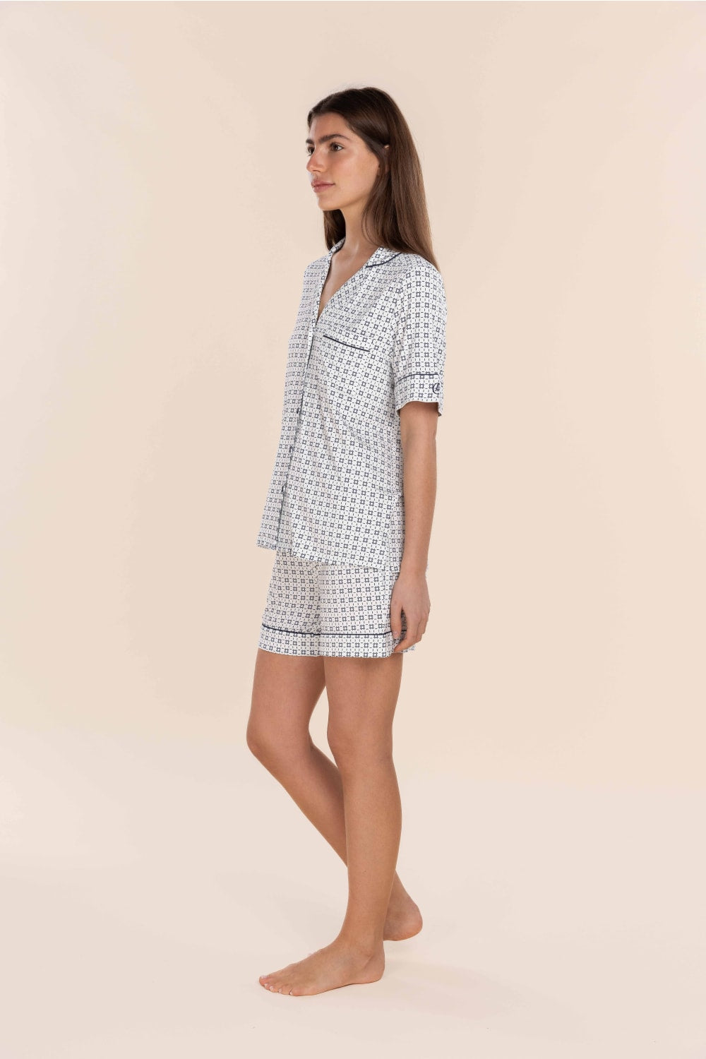 Woman wearing a patterned nightshirt on a beige background