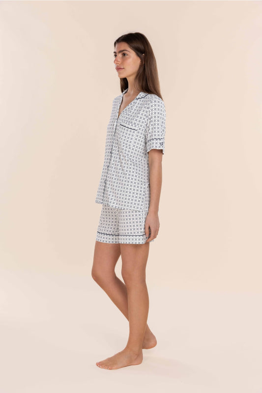 Woman wearing a patterned nightshirt on a beige background