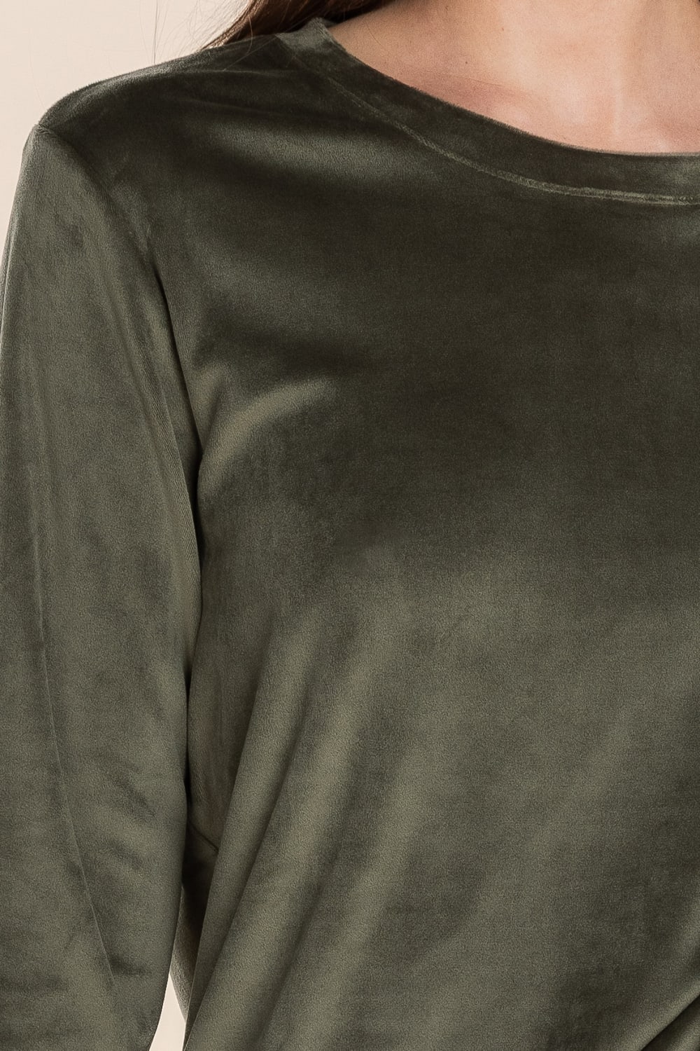 Close-up of a green long-sleeve shirt with a blurred background