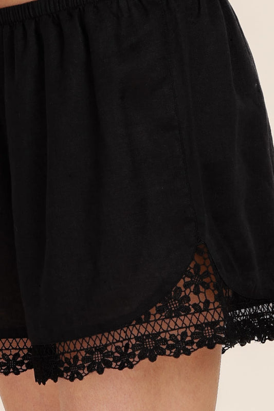 Black lace-trimmed skirt on a neutral background