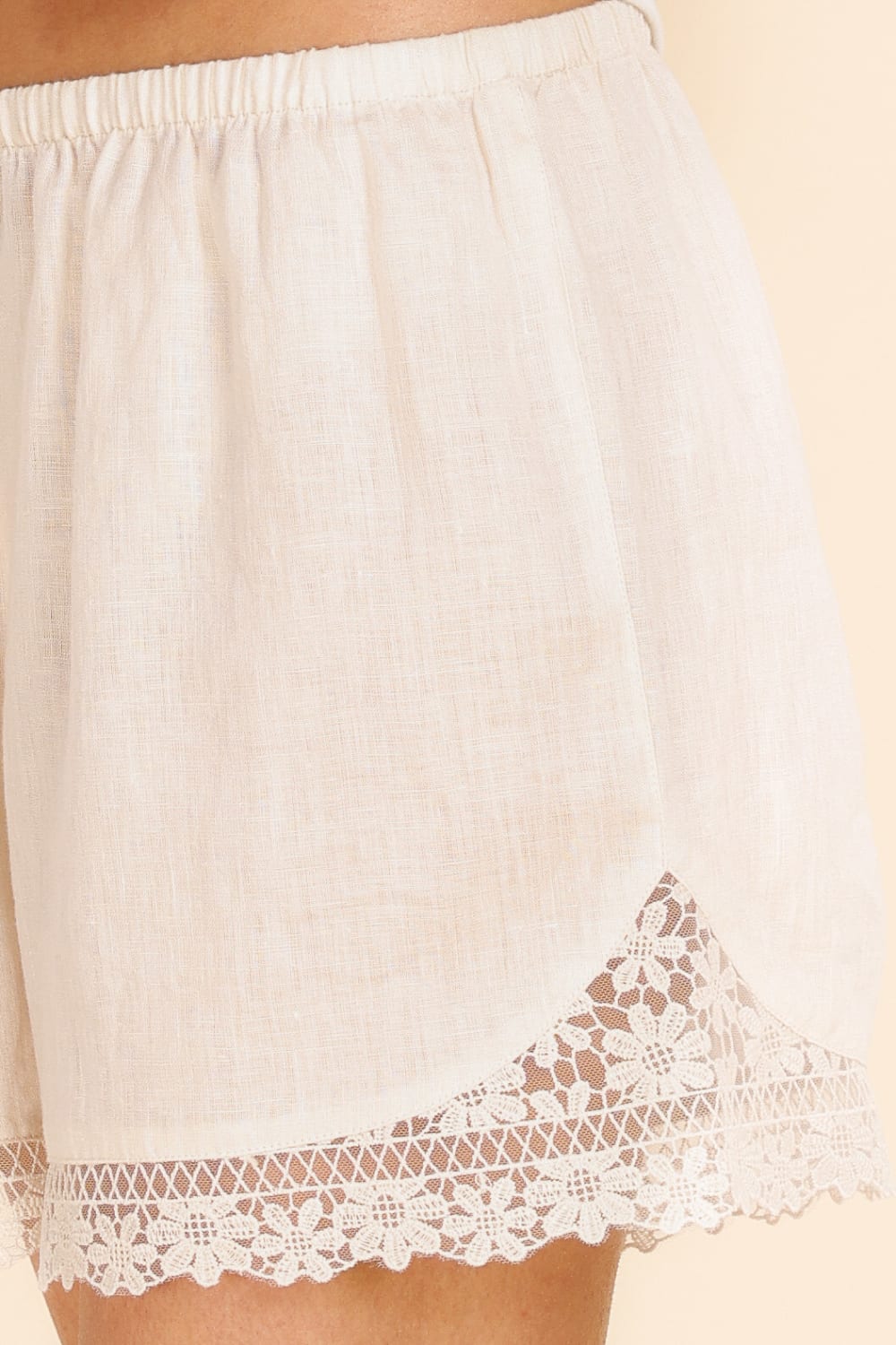 Beige lace-trimmed underwear on a beige background