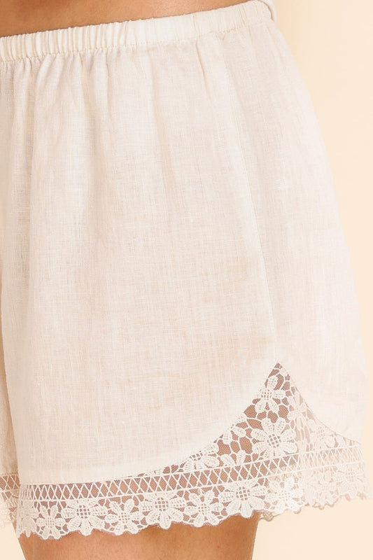 Beige lace-trimmed underwear on a beige background